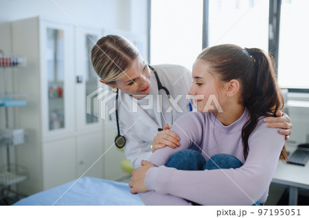 Close-up of doctor supporting teenage girl in her ambulance office. 97195051
