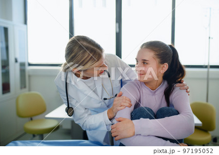 Close-up of doctor consoling teenage girl in her ambulance office. 97195052