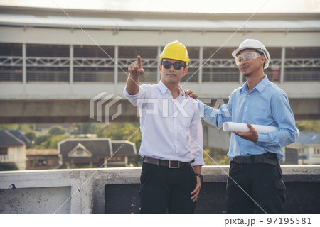 Civil Construction engineer teams shaking hands together wear work helmets worker on construction site. Foreman industry project working engineer teamwork. Two asian engineer team shake hands together Civil Construction engineer teams shaking hands together wear work helmets worker on construction site. Foreman industry project working engineer teamwork. Two asian engineer team shake hands together 97195581