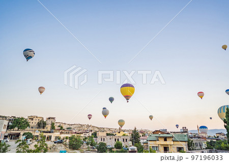 Colorful hot air balloon flying over Cappadocia, Turkey 97196033