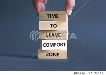 Leave comfort zone symbol. Concept words Time to leave comfort zone on wooden blocks. Businessman hand. Beautiful grey table grey background. Business time to leave comfort zone concept. Copy space. 97196414