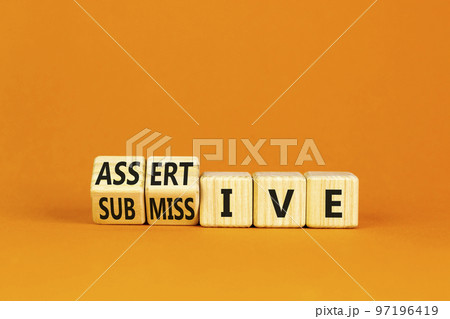 Submissive or assertive symbol. Concept words Submissive and assertive on wooden cubes. Beautiful orange background. Business, psychological submissive assertive concept. Copy space. Submissive or assertive symbol. Concept words Submissive and assertive on wooden cubes. Beautiful orange background. Business, psychological submissive assertive concept. Copy space. 97196419