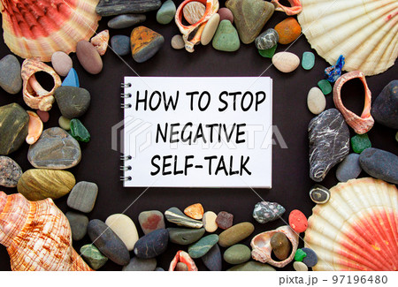 Stop negative self-talk symbol. Concept words How to stop negative self-talk on a beautiful black background. Sea stones and seashells. Psychological and stop negative self-talk concept. Copy space. 97196480