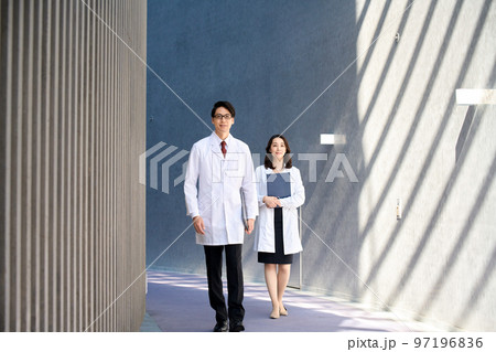 病院の廊下を歩く白衣を着た男女の医療イメージ 97196836