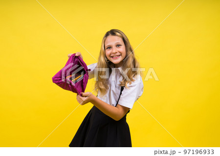 Happy schoolgirl with colored pencils and a pencil case in hand Happy schoolgirl with colored pencils and a pencil case in hand 97196933