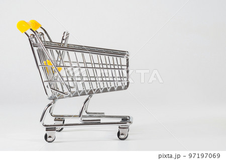 A close-up of an empty shopping cart at the white background with the empty space for texting A close-up of an empty shopping cart at the white background with the empty space for texting 97197069