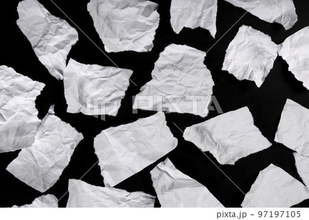 Pieces of torn paper, for message on black background 97197105