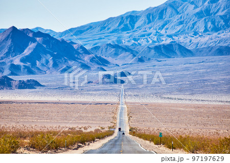 View of long endless road going up into desert mountains View of long endless road going up into desert mountains 97197629