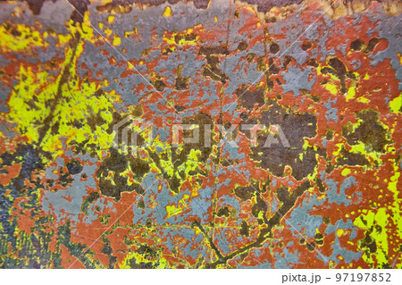 Abstract shot of chipped gray paint that reveals blues, yellows and reds Abstract shot of chipped gray paint that reveals blues, yellows and reds 97197852