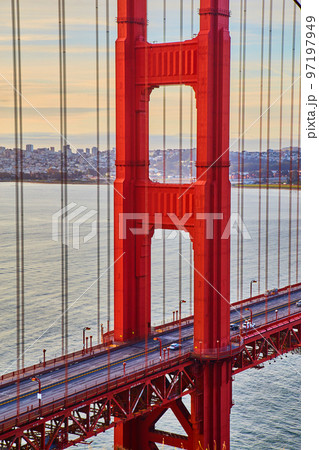 Morning traffic crossing vibrant red Golden Gate Bridge in San Francisco Morning traffic crossing vibrant red Golden Gate Bridge in San Francisco 97197949