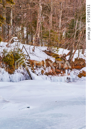 Frozen lake with damaged staircase to water level Frozen lake with damaged staircase to water level 97198531