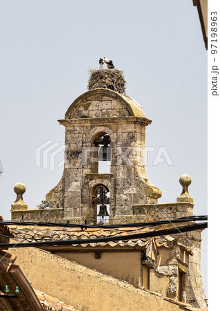 Storks on the Church of Santa Maria in Maderuelo in the province of Segovia, Spain 97198963