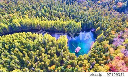 Aerial of a lake with a boat that pulls across the water at the Big Spring 97199351
