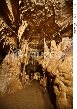 Cave pathyway with stalagmites and stalactites Cave pathyway with stalagmites and stalactites 97199534