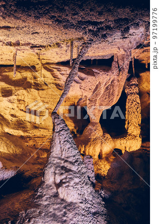Vertical of unusual cave formations stalagmites and stalactites joining Vertical of unusual cave formations stalagmites and stalactites joining 97199776