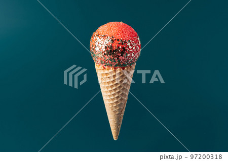 Christmas fun decorative fake ice cream cone on dark green background Christmas fun decorative fake ice cream cone on dark green background 97200318