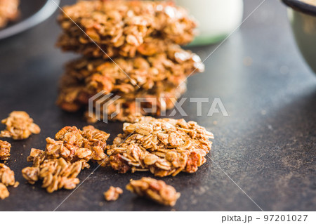Sweet oatmeal cookies on kitchen table. 97201027