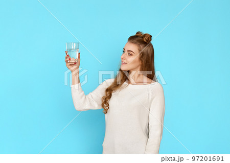 curly brunette woman with drinking glass of water 97201691