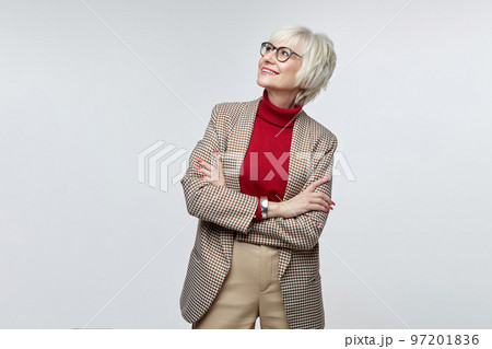 beautiful elderly woman with glasses looks at the free space. advertising concept of a business woman leader beautiful elderly woman with glasses looks at the free space. advertising concept of a business woman leader 97201836