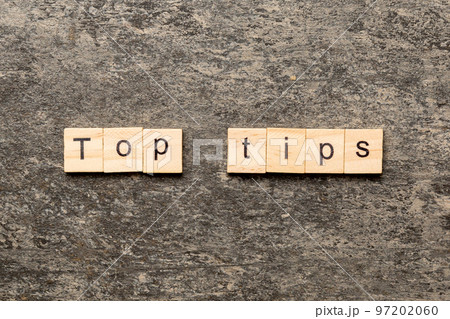 Top tips word written on wood block. Top tips text on cement table for your desing, Top view concept 97202060