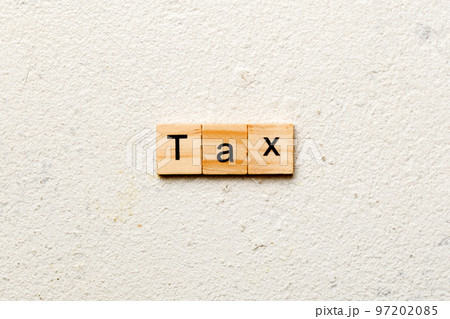 Tax word written on wood block. Tax text on cement table for your desing, concept Tax word written on wood block. Tax text on cement table for your desing, concept 97202085
