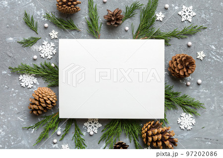 Flat lay Christmas composition. square Paper blank, pine tree branches, christmas decorations on Colored background. Top view, copy space for text 97202086