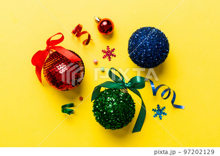 Christmas ball on colored background. decoration bauble with ribbon bow with copy space 97202129