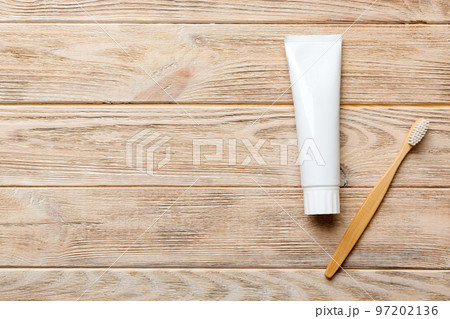 toothpaste and toothbrush top view with copy space on colored background. Flat lay. Dental hygiene. Oral care products on light background. Body care concept toothpaste and toothbrush top view with copy space on colored background. Flat lay. Dental hygiene. Oral care products on light background. Body care concept 97202136