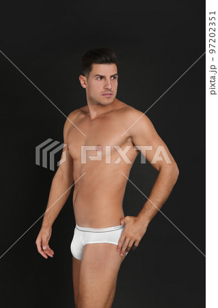 Handsome man in underwear on black background Handsome man in underwear on black background 97202351