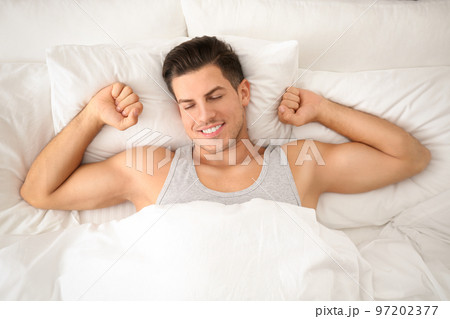 Man awakening in bed at home, top view. Lazy morning 97202377