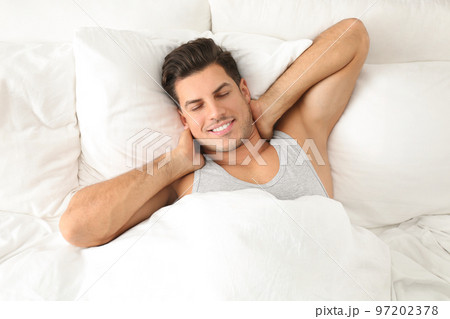 Man awakening in bed at home, top view. Lazy morning 97202378