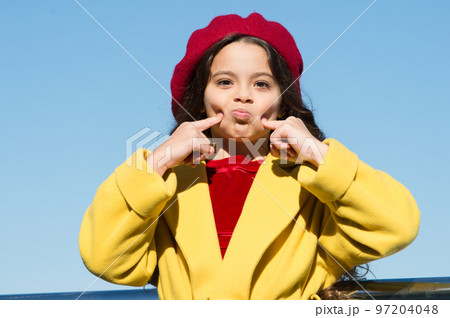 just playing. enjoy autumn day. lucky with weather. funny little lady. small girl outdoor. french style. kid fashion. stylish girl child after hairdresser. she has unreal curly hair. trip to france 97204048
