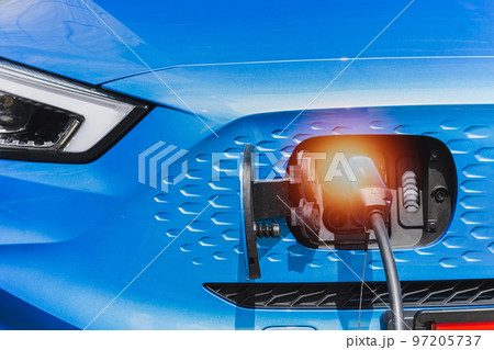 EV car charging outdoor at electric charging station. Electric vehicle. EV car charging outdoor at electric charging station. Electric vehicle. 97205737