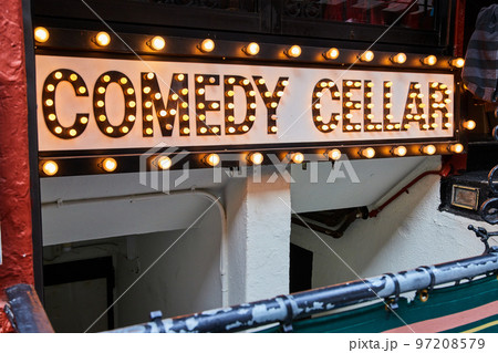 Comedy Cellar neon bulb lights sign going into basement in New York City Comedy Cellar neon bulb lights sign going into basement in New York City 97208579