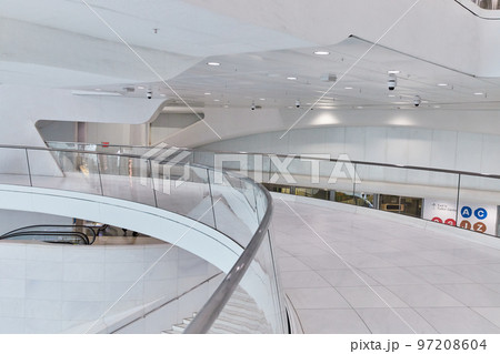 Clean white architecture path bridge with glass railing along inside New York City subway 97208604