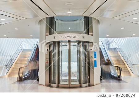 Clean modern elevator and stairs inside bright white subway of New York City 97208674