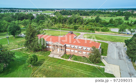 Aerial of stunning abandoned brick building with stone pillar entrance 97209035