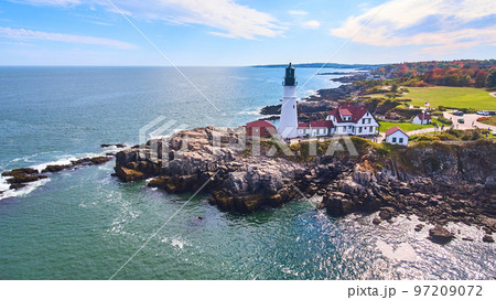 Stunning lighthouse on rocky cliffs in Maine from aerial view Stunning lighthouse on rocky cliffs in Maine from aerial view 97209072