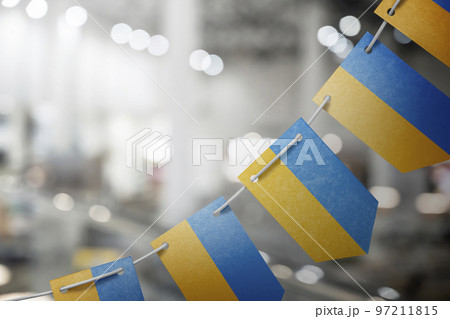A garland of Ukraine national flags on an abstract blurred background 97211815