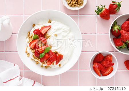 Yogurt with strawberry. Plain white greek yogurt with fresh berries and granola. Healthy food, breakfast. Top view 97215119