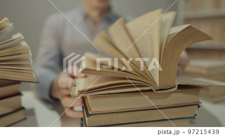 book close-up flipping pages. man reading a book in the library. education bookstore concept. university book turn pages slow motion video. bookstore hands men reading close-up lifestyle a book 97215439
