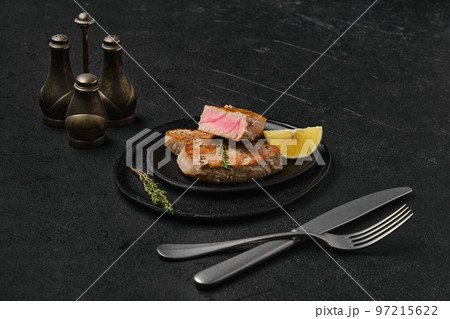 Fried tuna fillet on black background 97215622