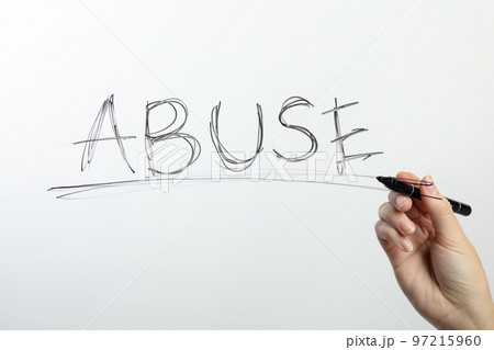Woman writing word ABUSE on glass against white background, closeup. Domestic violence awareness 97215960