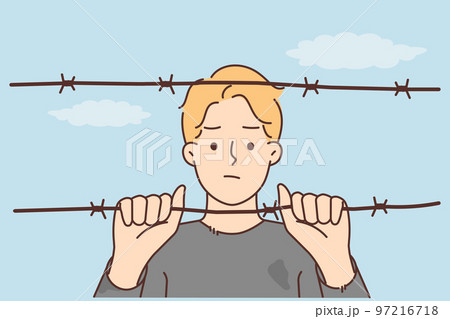 Man behind wires in prison Man behind wires in prison 97216718