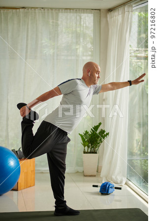 Mature man working out at home in the morning 97216802