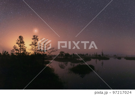 Amazing Glowing Stars Effects Above Landscape. Milky Way Galaxy In Night Starry Sky Above Rural Landscape In Summer Season. Real Colorful Night Stars Above Swamp 97217024