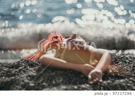 Woman in red dress on sea. Side view a Young beautiful sensual woman in a red long dress posing on the beach near sea on sunset. Girl on the nature on blue sky background. Fashion photo. Woman in red dress on sea. Side view a Young beautiful sensual woman in a red long dress posing on the beach near sea on sunset. Girl on the nature on blue sky background. Fashion photo. 97217298