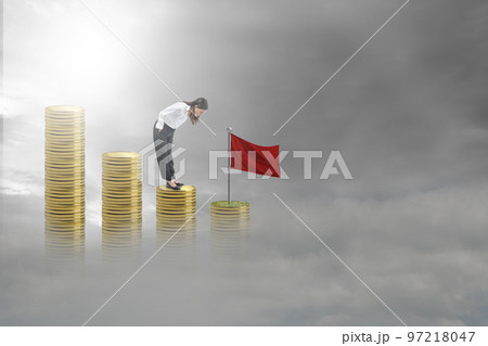 Asian businesswoman standing and looking down the coin stack Asian businesswoman standing and looking down the coin stack 97218047