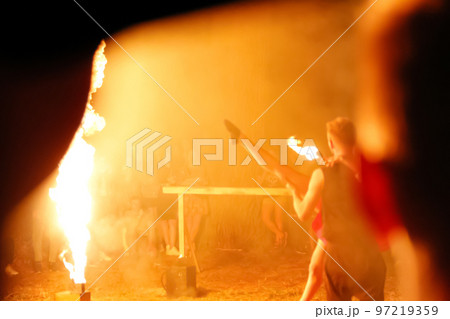 Defocus couple of dancers approach each other and begin to dance Argentine tango in fire flame background. Two dancers performing tango in orange stage lights. Blurred. Out of focus Defocus couple of dancers approach each other and begin to dance Argentine tango in fire flame background. Two dancers performing tango in orange stage lights. Blurred. Out of focus 97219359