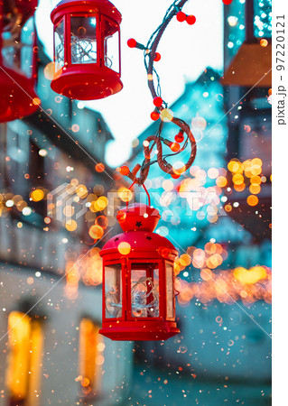 Red Christmas lantern and fairy lights. Beautiful bokeh and snow flakes 97220121